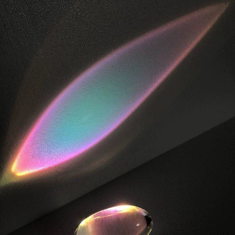 Sunset lamp projector creating relaxing orange and pink light effect.